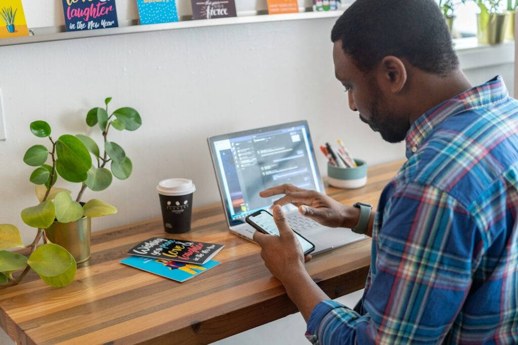 man sitting at a desk in front of a computer